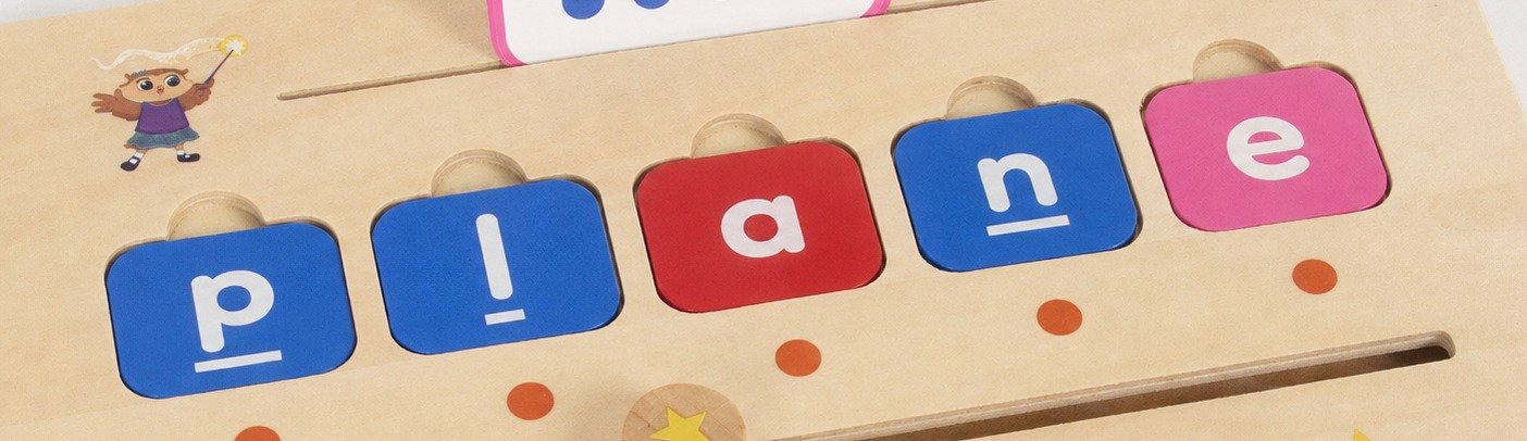The wooden board has orange position dots below its tile slots