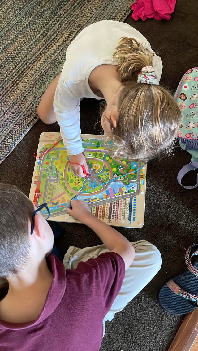 Customer photo from Rogers showing children sharing the Storytime Magnetic Maze