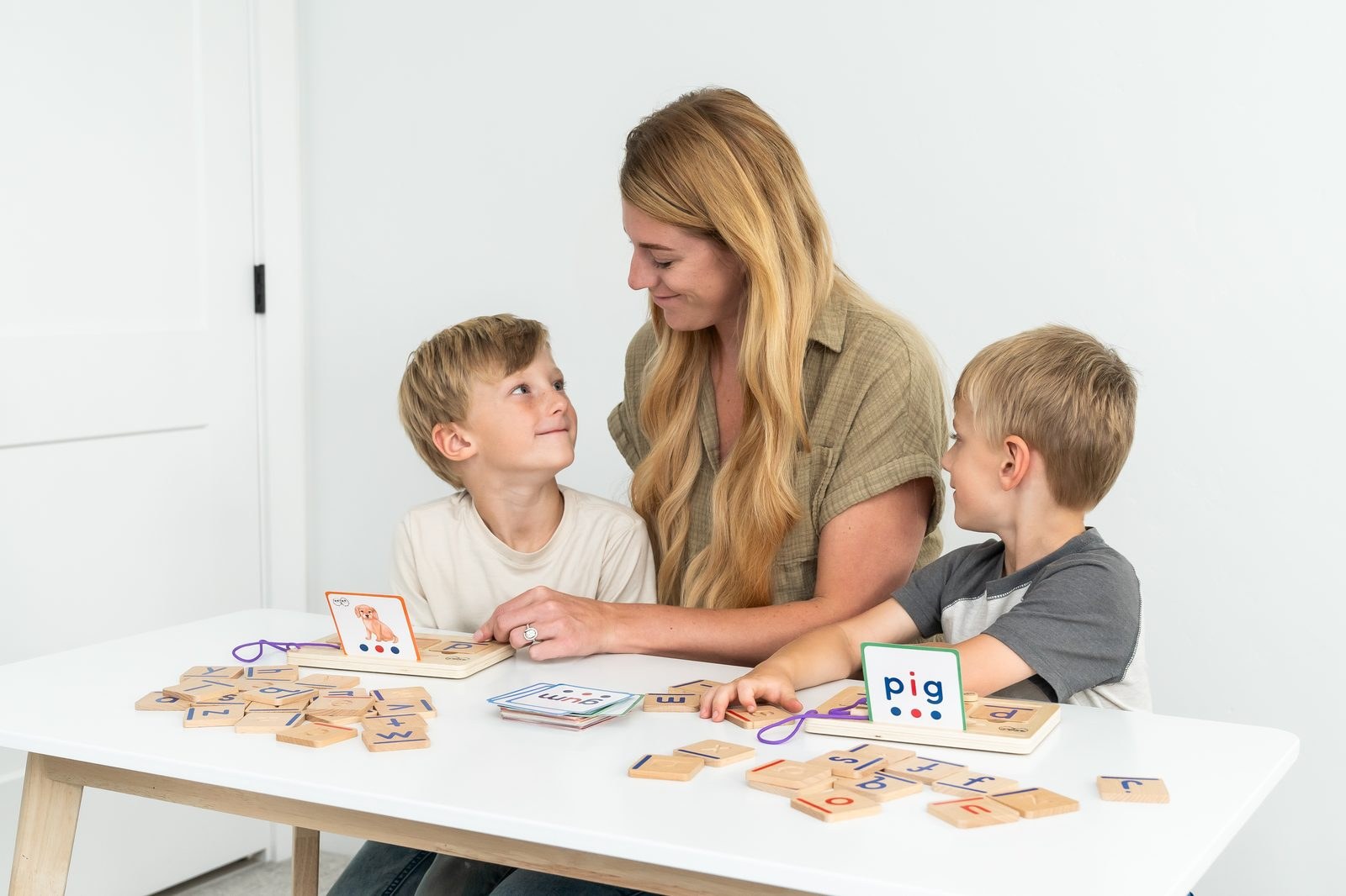 A family exploring wooden learning toys together