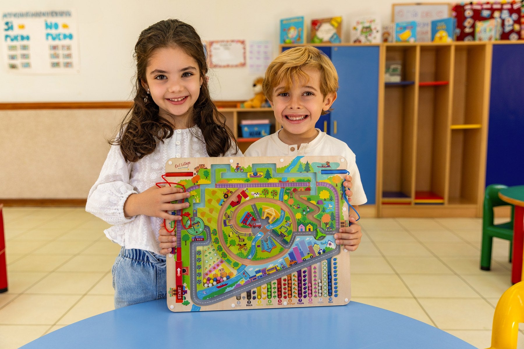 Two children holding the Storytime Magnetic Maze